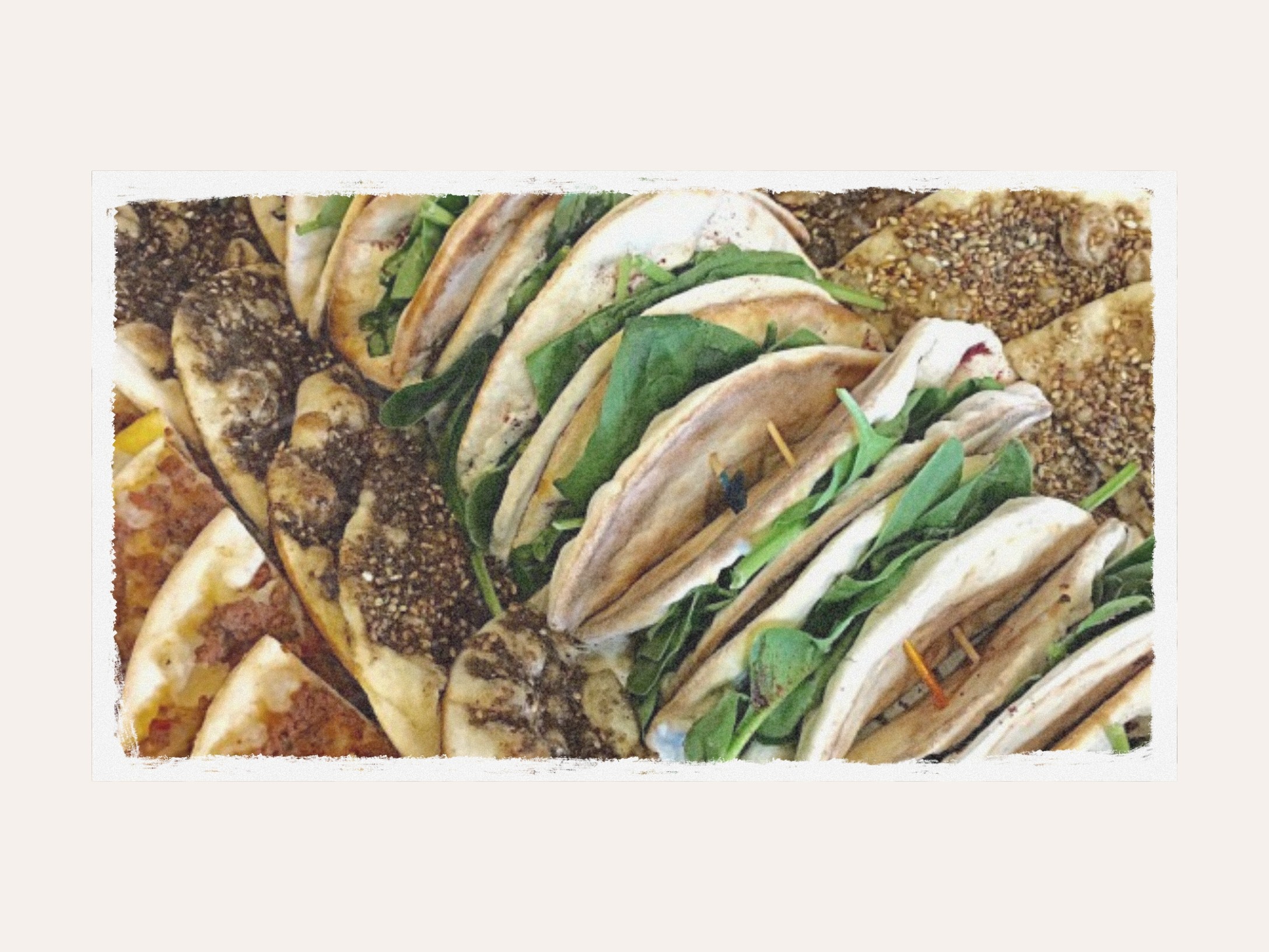 A stack of saj wraps filled with greens and zaatar
